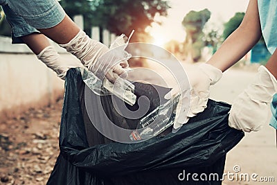 Mother and child help picking up trash Stock Photo