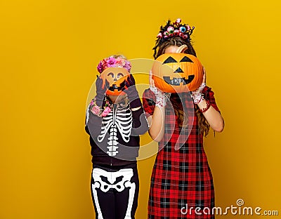 Mother and child holding jack-o-lantern pumpkins Stock Photo
