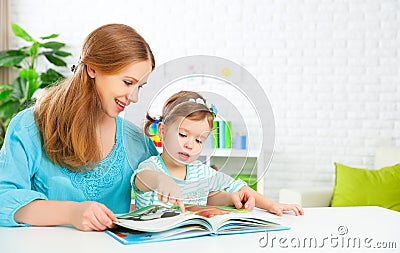 Mother and child reading book at home Stock Photo