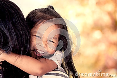 Mother and child resting on her mother`s shoulder Stock Photo