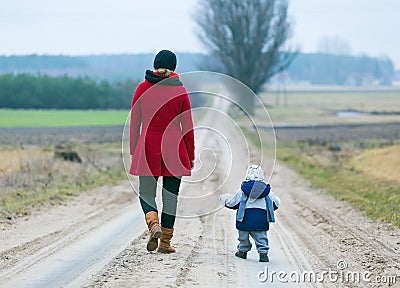 Mother and child on sandy road Stock Photo