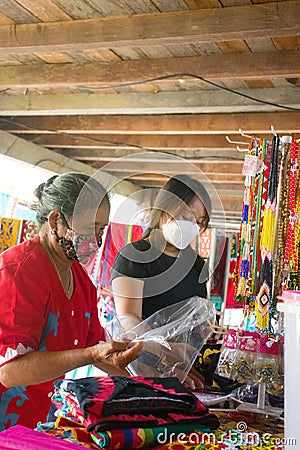 mother and child are selling traditional clothes of the Dayak Tunjung tribe Editorial Stock Photo