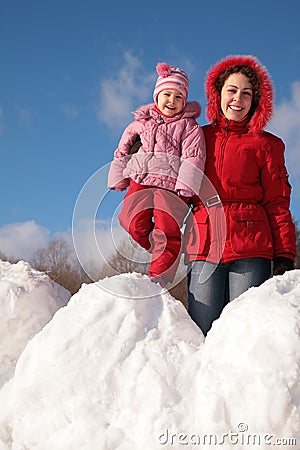 Mother and child on snowdrift Stock Photo