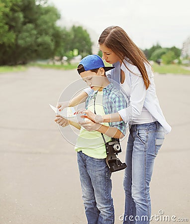 Mother and child tourists sightseeing city with map Stock Photo