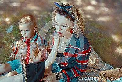 Mother with children are esating fresh berries Stock Photo