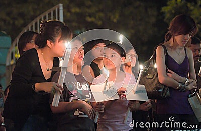 Mother and Children at Good Friday Mass Editorial Stock Photo