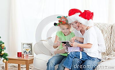 Mother and children looking a christmas calendar Stock Photo