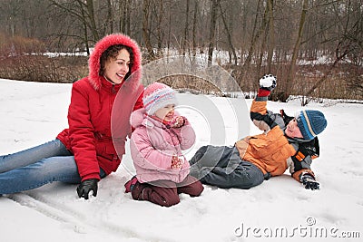 Mother and children play in winter park Stock Photo