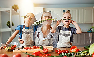 Mother with children preparing vegetable salad Stock Photo