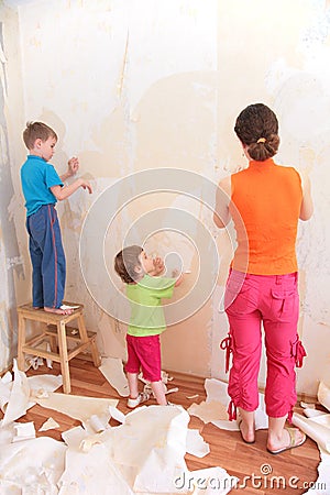 Mother with children remove old wallpapers Stock Photo