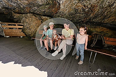 Mother with children sit on bench in Liechtensteinklamm or Liechtenstein Gorge, Austria Stock Photo