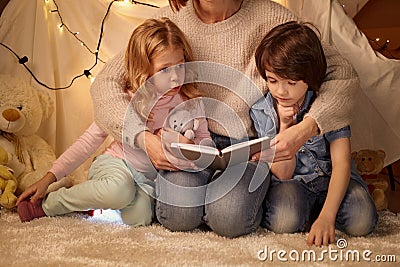 Mother and children sitting in playroom Stock Photo