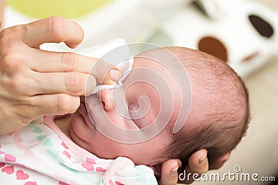 Mother cleaning eyes of a newborn baby Stock Photo