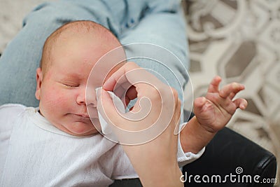 Mother cleaning eyes of a newborn baby Stock Photo