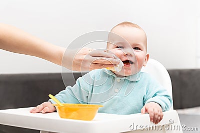 Mother Cleaning Her Son With Baby Wipes Stock Photo