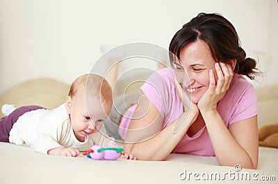 Mother with cute baby on bed Stock Photo