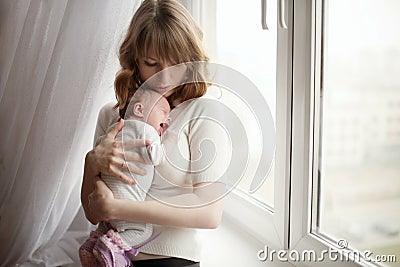 Mother with cute little crying baby Stock Photo