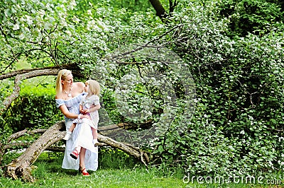 Mother and daughter in blooming garden Stock Photo