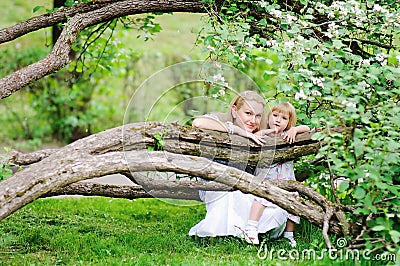 Mother and daughter in blooming garden Stock Photo
