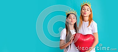 Mother and daughter child banner, copy space, isolated background. Selfish woman and girl child in crowns air kiss Stock Photo