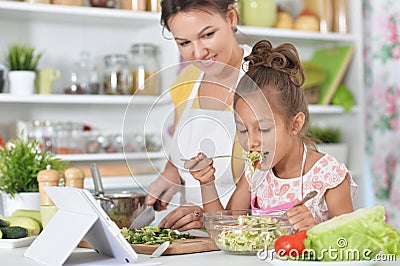 Mother and daughter cooking together Stock Photo