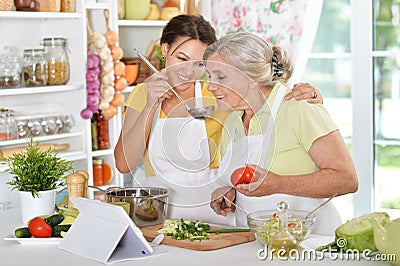 Mother and daughter cooking together Stock Photo