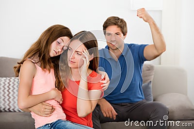 Mother And Daughter Depressed With Violent Father Stock Photo