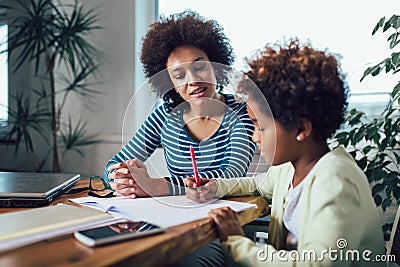 Mother and daughter doing homework learning to calculate Stock Photo