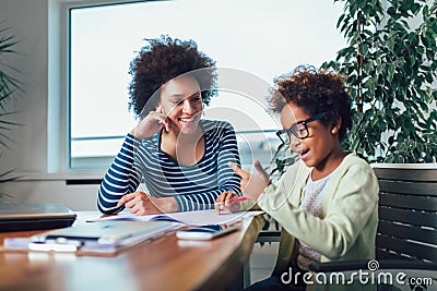 Mother and daughter doing homework learning to calculate Stock Photo