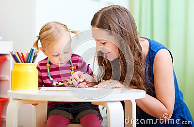 Mother and daughter drawing together Stock Photo