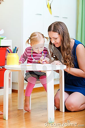 Mother and daughter drawing together Stock Photo