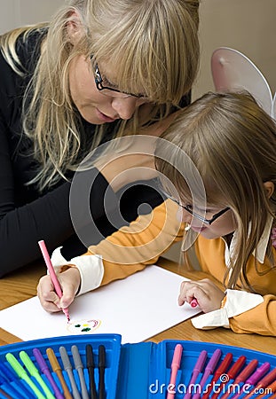 Mother and daughter drawing together Stock Photo