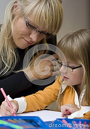 Mother and daughter drawing together Stock Photo