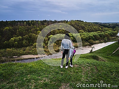 Mother and daughter enjoys the view on the coast Sluch river Stock Photo