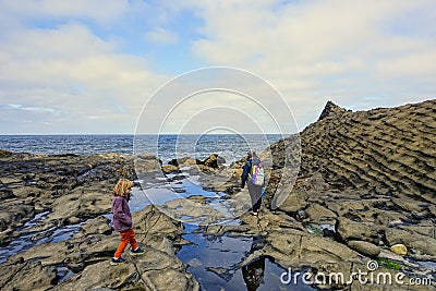 A mother and daughter exploring the tidal pools off of North Beach, in Naikoon Provincial Park Stock Photo