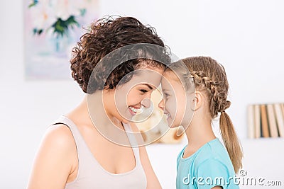 Mother and daughter are grinning to each other Stock Photo