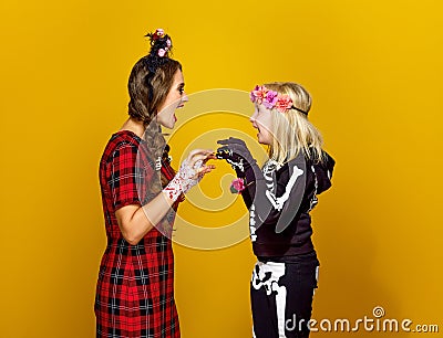 Mother and daughter in halloween costume frightening each other Stock Photo