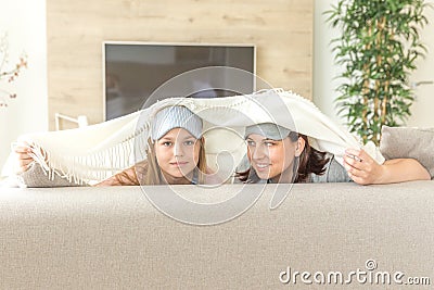 Mother and daughter happ family concept. wearing sleeping mask and having fun on sofa in living room Stock Photo