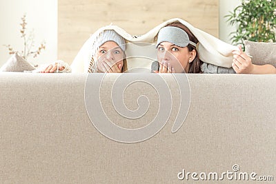 Mother and daughter happ family concept. wearing sleeping mask and having fun on sofa in living room Stock Photo