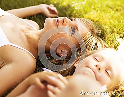 Mother with daughter having fun on grass Stock Photo