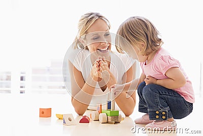 Mother and daughter indoors playing Stock Photo