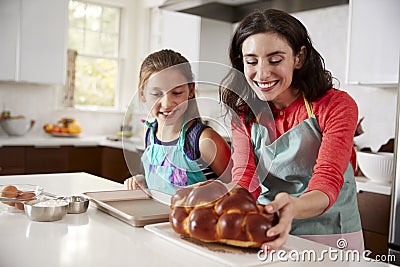 Mother and daughter in kitchen with freshly baked challah Stock Photo
