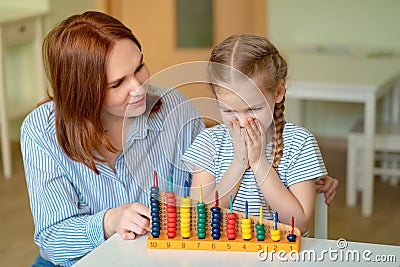 Mother with daughter learning to add and subtract Stock Photo