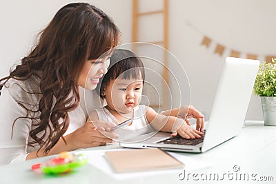 Mother and daughter are learning to write. Stock Photo