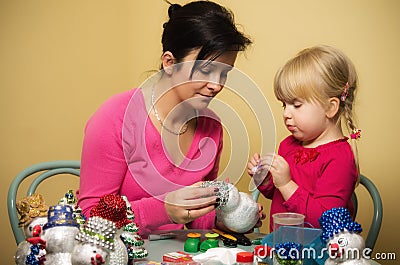 Mother and daughter making Christmas decorations Stock Photo