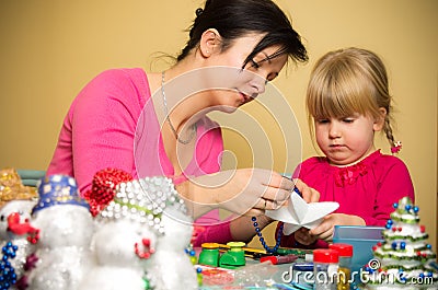 Mother and daughter making Christmas decorations Stock Photo