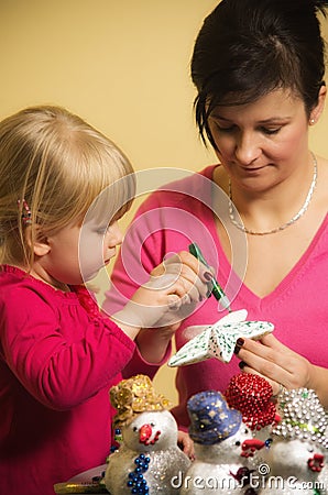 Mother and daughter making Christmas decorations Stock Photo