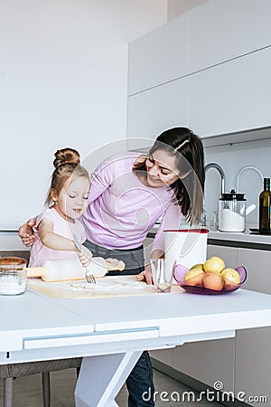 Mother And Daughter Making Cookies Stock Photo