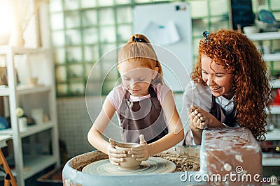 Mother and daughter mold with clay on pottery Stock Photo