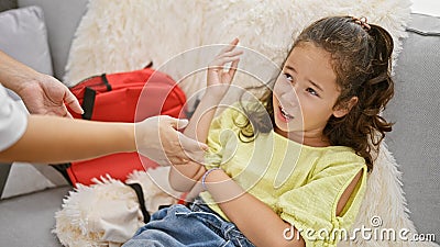 Mother and daughter passionately arguing at home on their cozy living room sofa, two family members expressing stress over Stock Photo